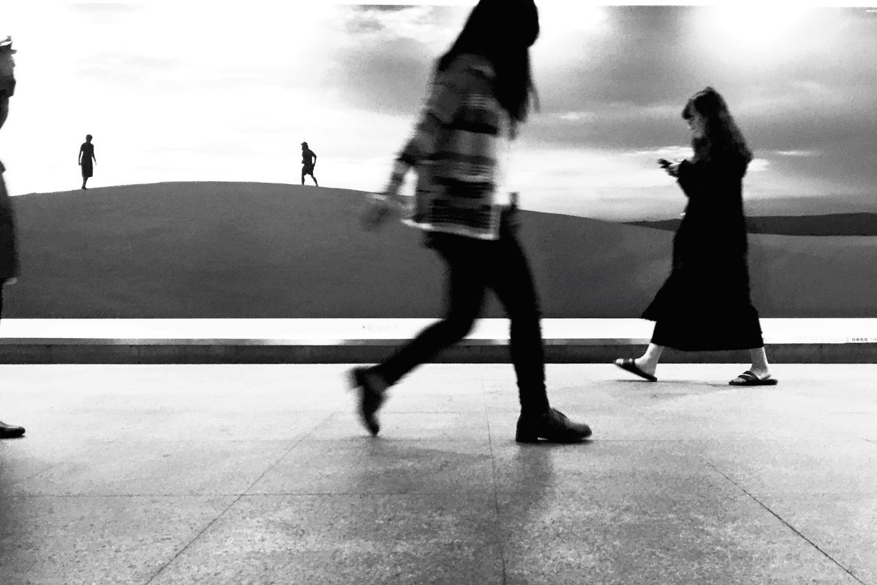 lifestyles, men, walking, person, leisure activity, togetherness, shadow, silhouette, full length, standing, sunlight, city life, medium group of people, bonding, tiled floor, travel, rear view