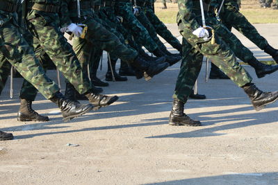 Low section of soldiers walking on road