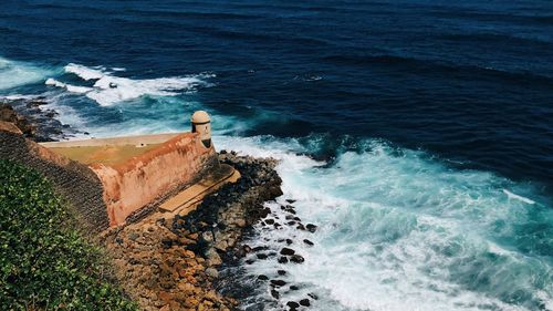 High angle view of wave splashing on fortified wall