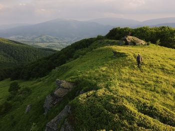Scenic view of green landscape against sky