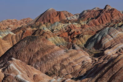 Rock formation on landscape against sky. zhangye danxia-red cloud nnal.geological park, gansu, china