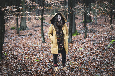 Full length of man standing in forest