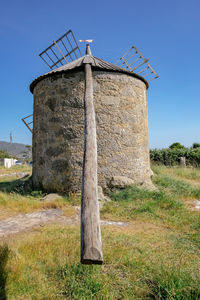 Built structure on field against sky