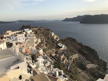 High angle view of townscape by sea against sky