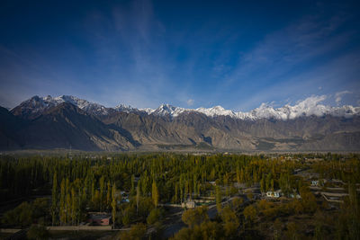 Scenic view of snowcapped mountains against blue sky