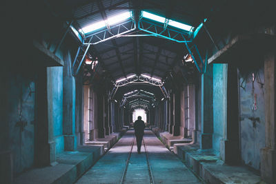 Full length of woman walking in tunnel