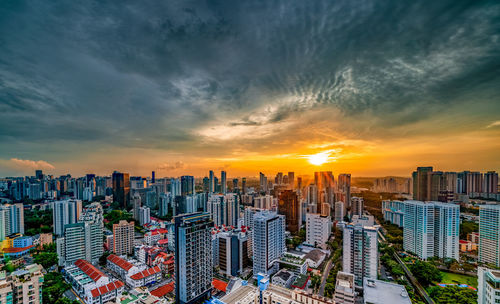 Panoramic view of city buildings against sky during sunset