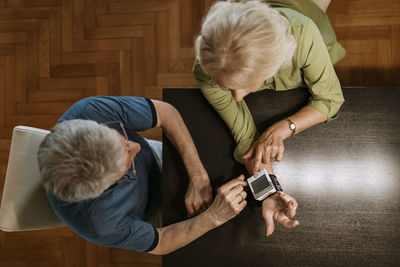 Senior couple taking blood pressure