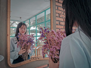 Woman standing by window