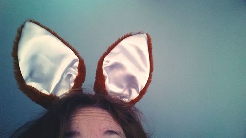 Cropped image of woman wearing bunny ears