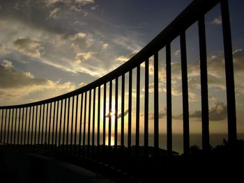 Silhouette bridge against sky during sunset