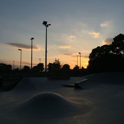 Road against cloudy sky at sunset