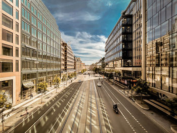 Vehicles on road against buildings in city