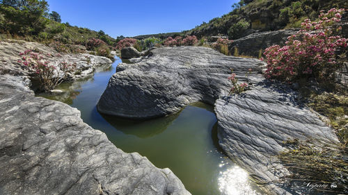 Scenic view of waterfall against sky