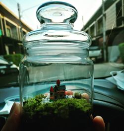 Close-up of people in glass jar