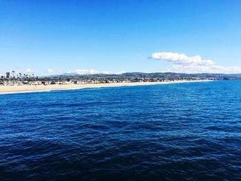 Scenic view of sea against blue sky