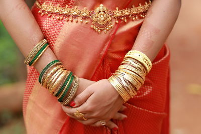 Midsection of woman with henna tattoo