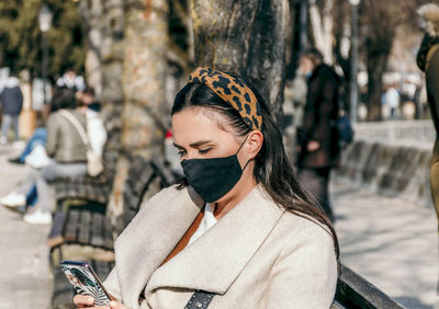 Portrait of young woman wearing hat outdoors