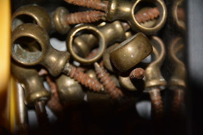 Close-up of metallic screws in container