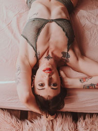 Portrait of woman lying on bed