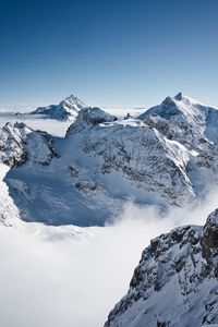 Scenic view of snowcapped mountains against clear sky