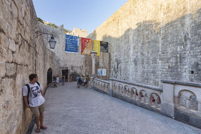 Man standing amidst old walls