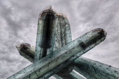 Low angle view of tower against cloudy sky