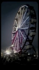 Low angle view of ferris wheel against sky