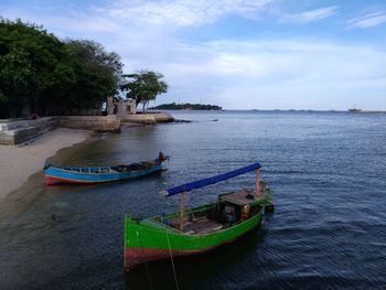 High angle view of boats moored in sea against sky