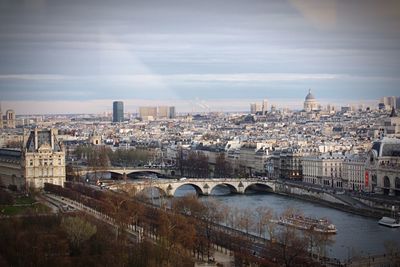 Cityscape against cloudy sky