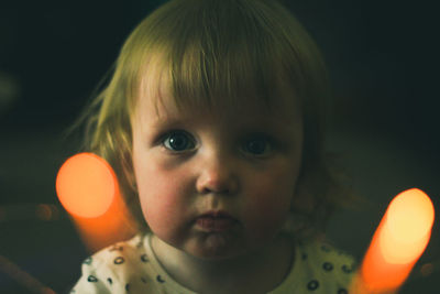 Close-up portrait of cute girl at home