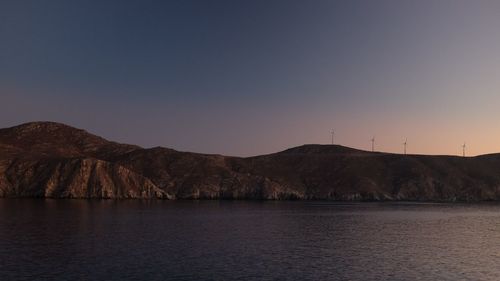 Scenic view of river and mountains against clear sky