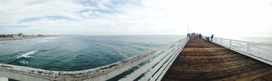 Panoramic view of pier in sea against sky