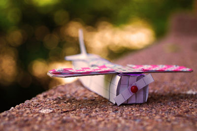 Close-up of paper airplane on steps