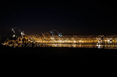 Low angle view of illuminated sky at night