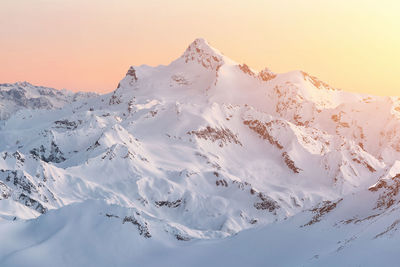 Scenic view of snow covered mountains against sky