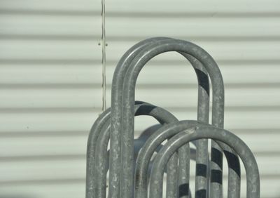 Close-up of metal railing against wall