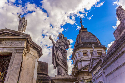 Low angle view of statue against cloudy sky