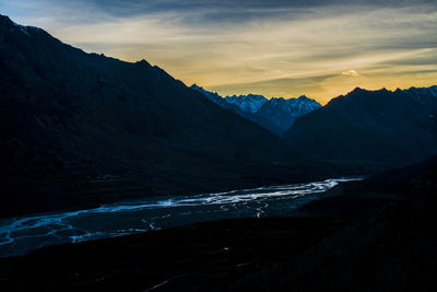 Scenic view of snowcapped mountains against sky during sunset