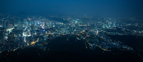 Aerial view of city lit up at night