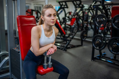 Portrait of young woman exercising in gym