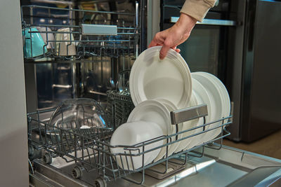 Cropped hand of man holding container