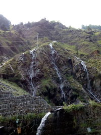 Scenic view of waterfall against sky