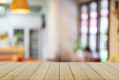 Defocused image of illuminated lights on table at home