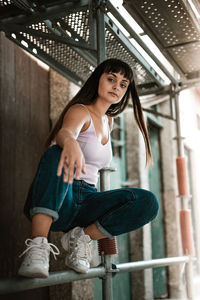 Portrait of young woman sitting outdoors