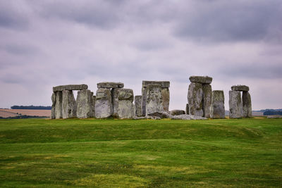 Rock formations on field against sky