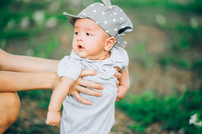 Portrait of cute boy looking away outdoors