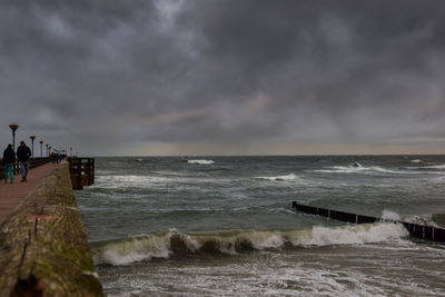 Scenic view of sea against storm clouds