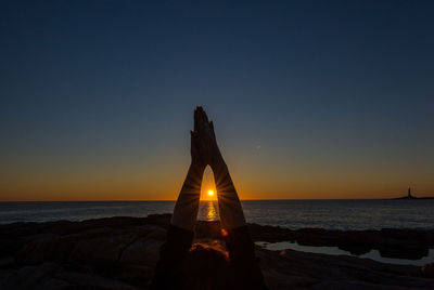 Scenic view of sea against clear sky during sunrise yoga session