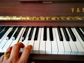 Close-up of woman hand with piano